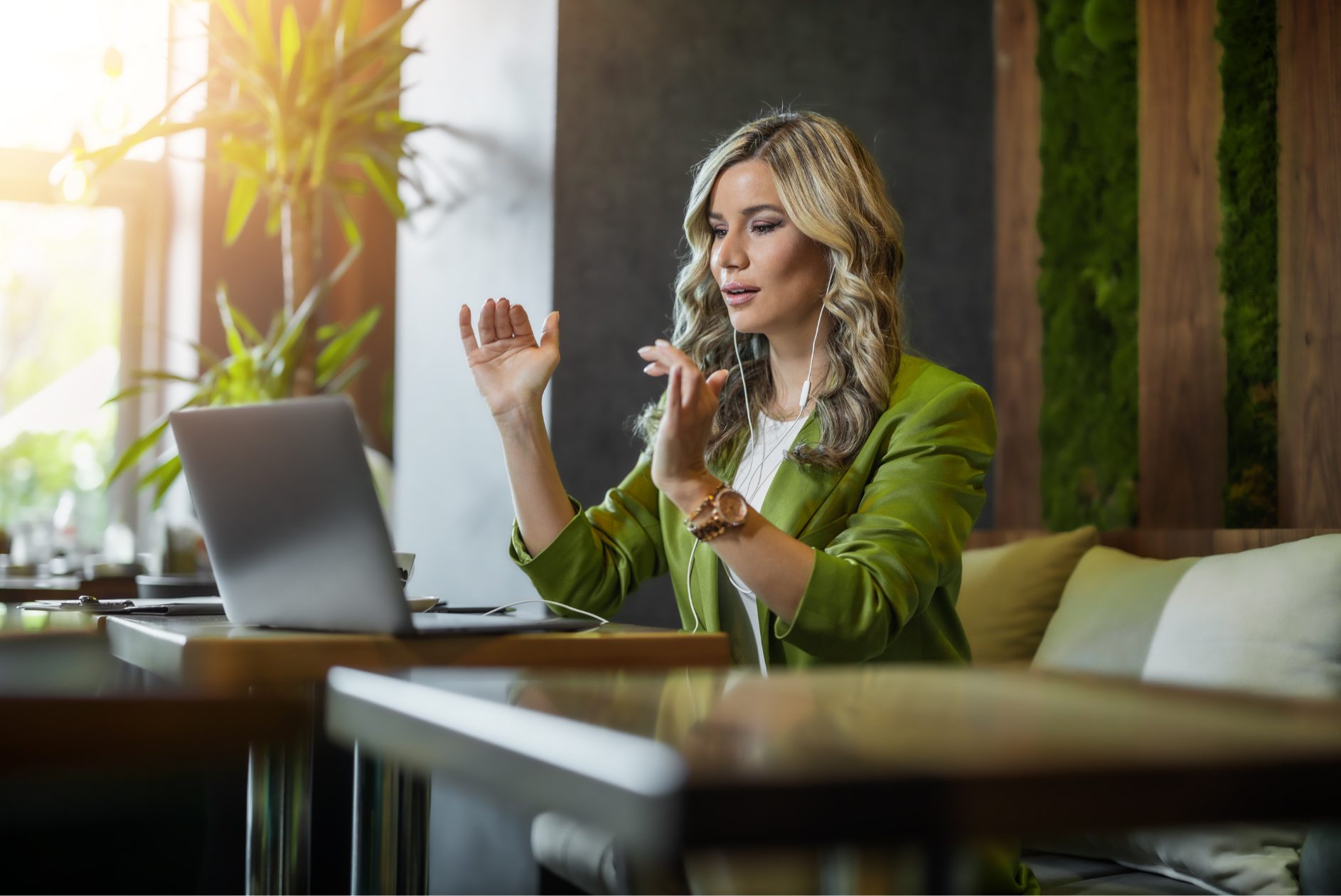 Woman in a remote meeting at a cafe